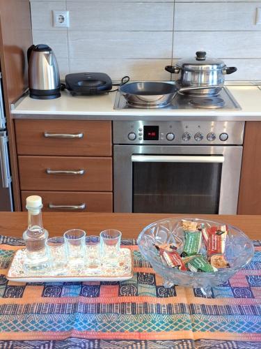 a kitchen with a table with a pot on a stove at Unlimited view - elegant apt 59 m2 w 37 m2 balc w prk in Ioannina