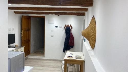 a kitchen with white walls and wooden ceilings at La Scogliera in Alghero