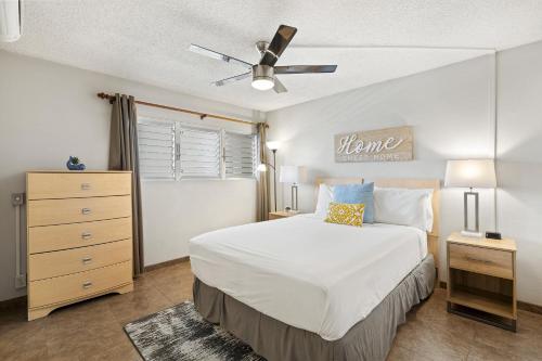 a bedroom with a bed and a ceiling fan at Island Surf 304 - Renovated, Ocean Views, Split AC in Kihei
