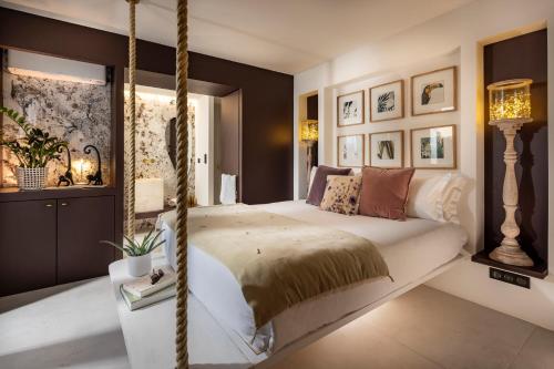 a bedroom with a large bed with a hanging bedvisor at La Bastide de Damien, 5 clefs Demeure d'Exception et Table Remarquable dans le guide Teritoria, JACUZZI Privatif, Cuisine étoilée Dominique Frérard in Aix-en-Provence