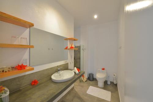 a bathroom with a sink and a toilet at Diniview Villa Resort in Boracay