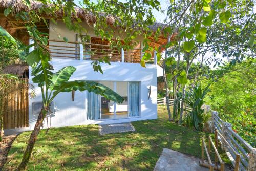 a white house with a window in a yard at Diniview Villa Resort in Boracay