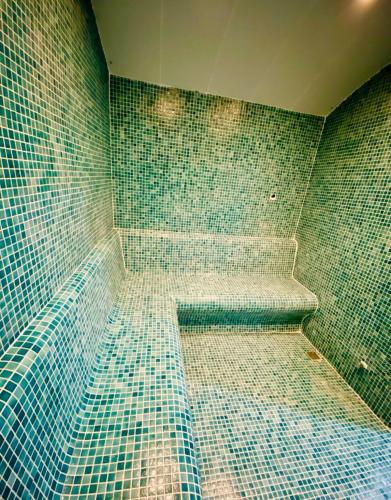 a bathroom with blue mosaic tiles on the wall at Sunny Shores Holiday in Alanya
