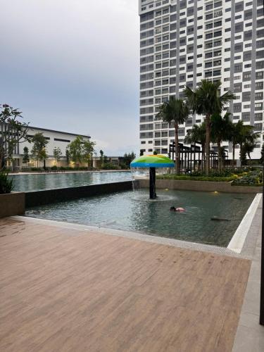 a person swimming in a pool with an umbrella at Cheras Trader Park By JR in Cheras