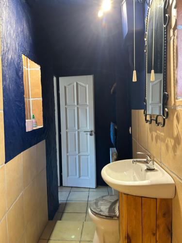 a bathroom with a white sink and a toilet at Lazy Days in Debrecen