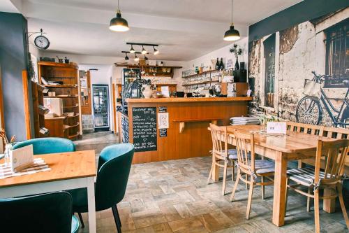 a restaurant with a wooden table and chairs at Apartmán Kafíno in Nové Město na Moravě