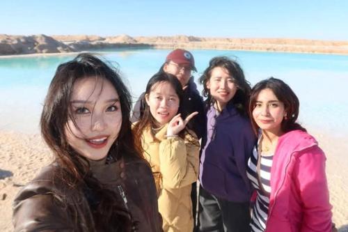 a group of people standing on the beach at Gazrashek Siwa Hot spring& trips Haven in Siwa