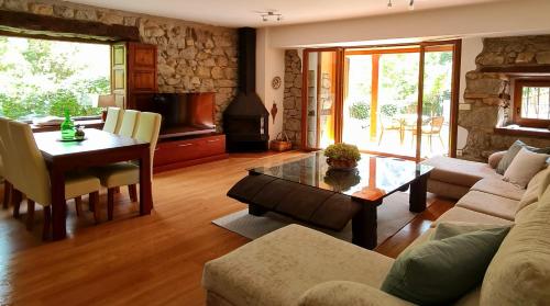 a living room with a couch and a table at El Jardín de la Peña in Castro