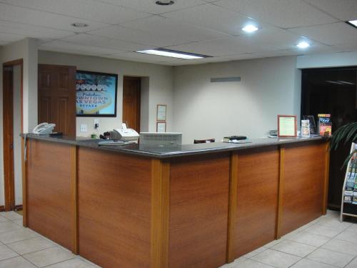 a lobby with a large wooden counter with a phone at City Center Motel in Las Vegas