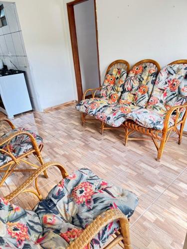 a living room with three chairs and a table at Casa Clarice in Alto Caparao