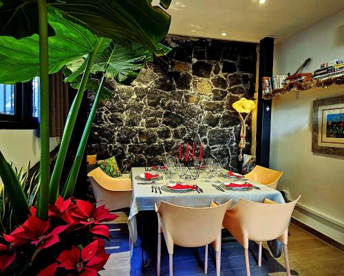 a dining room with a table and some plants at La Foresteria Garden Boutique B&B in Catania