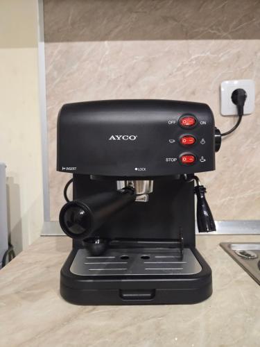 a black coffee maker sitting on top of a counter at Apartment Tryavna in Tryavna