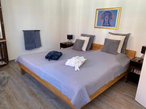 a bedroom with a bed with towels on it at Gästehaus LuNa in Zeil