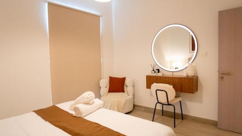 a bedroom with a bed and a mirror and a chair at Noor Homes - Luxury Approved by the Department of Culture and Tourism, Abu Dhabi in Yas Island in Abu Dhabi