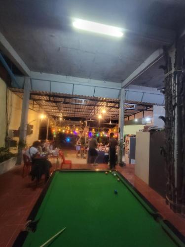 a pool table in the middle of a room with people at Top View Kohrong in Koh Rong