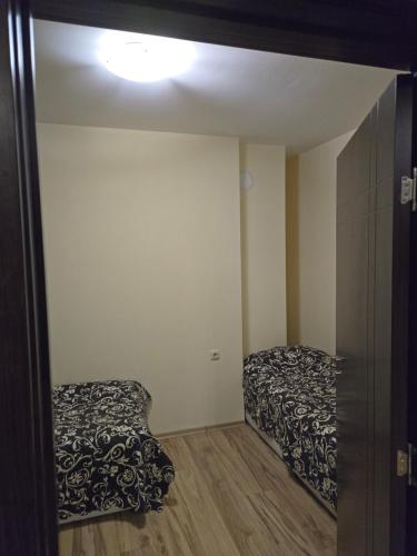 a room with two beds and a mirror at Apartment Tryavna in Tryavna
