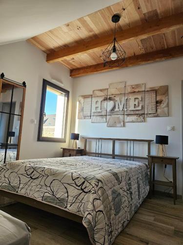 a bedroom with a bed in a room with wooden ceilings at Logement proche Bourboule 12 personnes in Massanges
