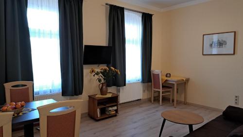 a living room with a couch and a table at Pension am Elberadweg in Radebeul