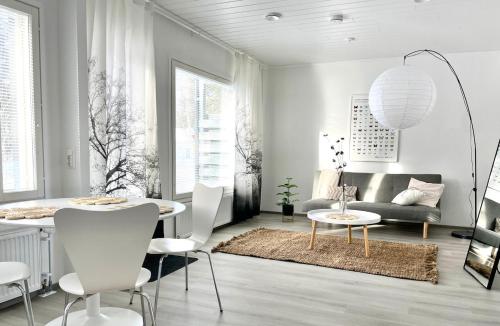 a living room with a table and a couch at Valoisa uusi kaksio keskellä Suomea in Haapavesi