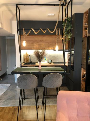a dining room with a table and two chairs at City View Duplex - Stylish 2BR Apartment with parking in Skopje