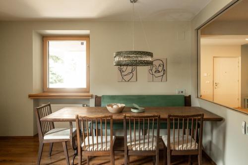a dining room with a wooden table and chairs at 240qm Luxus Apartment - Natur & Wandern zw Bozen und Meran in Nalles