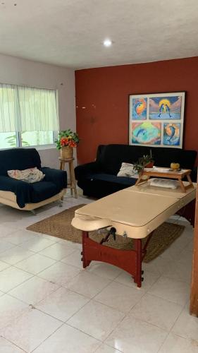 a living room with a couch and a table at Ocean View PLAYA DEL NIÑO Rooms & Apartments in Cancún