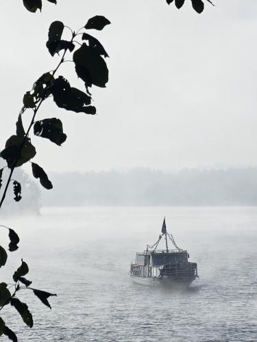 a ferry boat on the water on a foggy day at Tresna Dream in Tresna