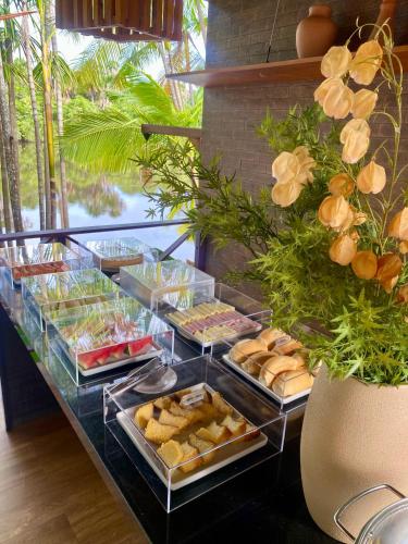 a buffet with trays of food on a table at Pousada Casa Dunas in Barreirinhas