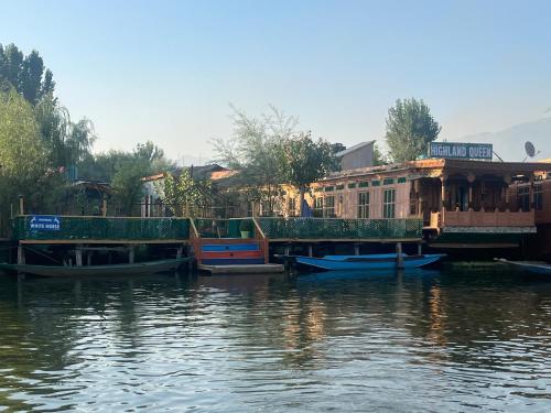 a group of houses on the side of a river at Hotel sea face in Srinagar