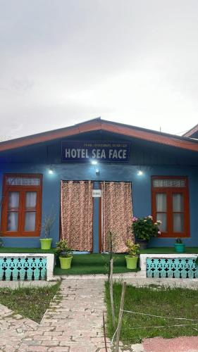 a blue building with a hotel star rate sign on it at Hotel sea face in Srinagar
