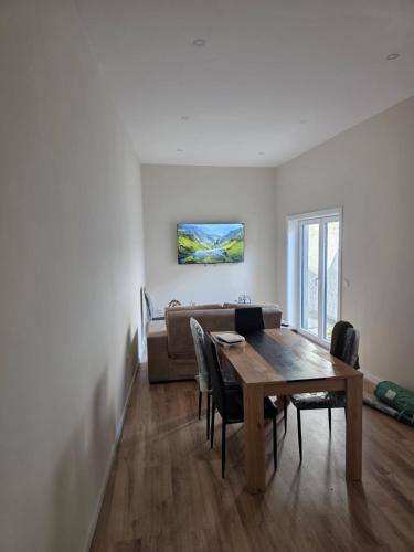 a living room with a table and a couch at Margens do Rio in Vila do Conde