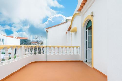 a balcony of a house with a white fence at HAUS NUNES by Stay in Alentejo in Vila Nova de Milfontes