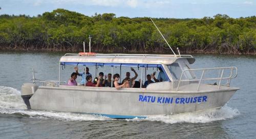 a group of people on a boat in the water at Ratu Kini Dive & Stay in Mana Island