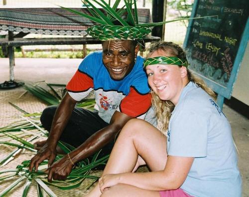 a man and a woman sitting on a bench at Ratu Kini Dive & Stay in Mana Island