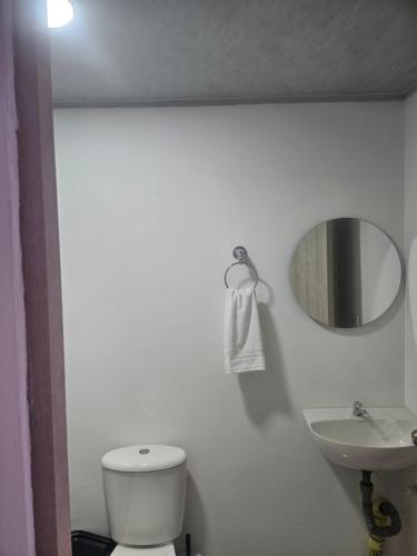 DosquebradasにあるLa Estrellaの白いトイレと洗面台のあるバスルーム