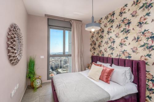 a bedroom with a bed with a floral wall at Unique Masterpiece in the Heart of Jerusalem in Jerusalem