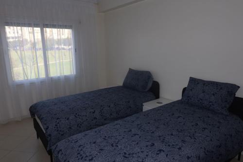 a bedroom with two beds and a window at Luxury 3 Bedroom apartment Iberia in Tangier