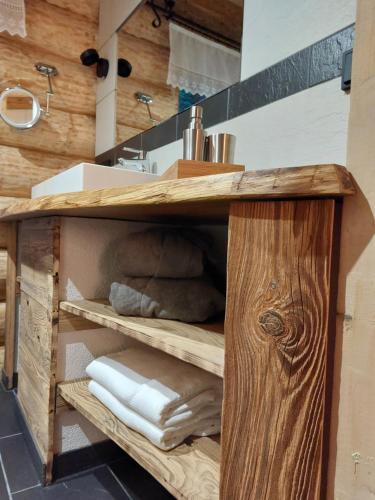 a bathroom with a wooden vanity with towels at Apart Lechtraum in Stanzach