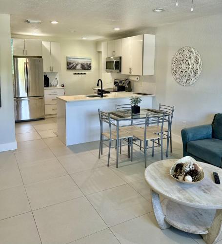 a kitchen and living room with a table and chairs at Close to everything! Perfect basecamp for WPB in West Palm Beach
