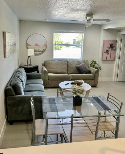 a living room with a couch and a table at Close to everything! Perfect basecamp for WPB in West Palm Beach