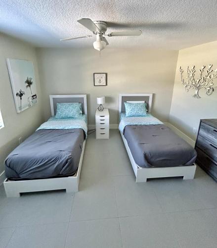 a bedroom with two beds and a ceiling at Close to everything! Perfect basecamp for WPB in West Palm Beach