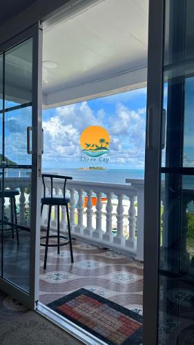 a view of the ocean from the balcony of a house at Posada Three Cay Suites in Providencia
