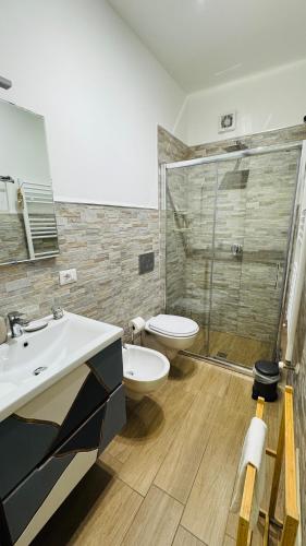 a bathroom with a toilet and a sink and a shower at Cala Portavecchia in Monopoli