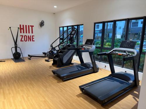a gym with treadmills and ellipticals in a room at Cheras Trader Park By JR in Cheras