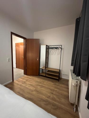 a bedroom with a mirror and a closet and a bed at Terrassenwohnung City an der Kleinen Weser in Bremen