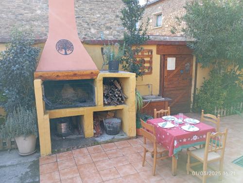 a outdoor patio with a fireplace and a table and chairs at EL PINAR DE BARDENA in Carcastillo