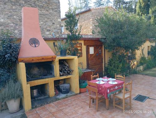 a outdoor patio with a table and a fireplace at EL PINAR DE BARDENA in Carcastillo