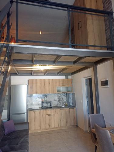 a room with a kitchen with a loft at Bakery apartments in Perea