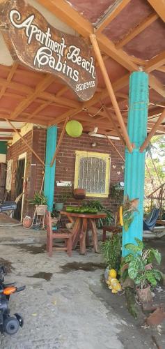 a restaurant with a table and a sign on a building at Beach cabin ometepe in Altagracia