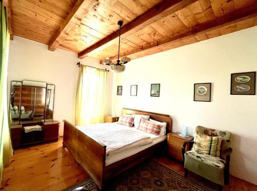 a bedroom with a bed and a wooden ceiling at TerraVino Retreat at Lake Balaton in Balatonlelle